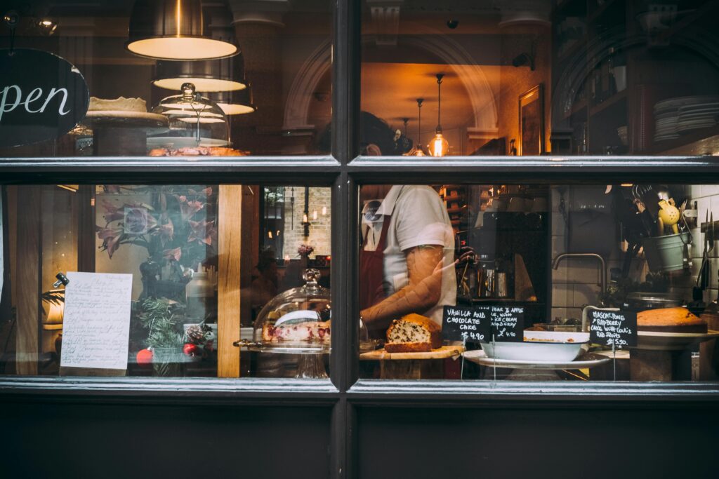 pexels-photo-1739748-1739748 Warm bakery scene in London through window showcasing pastries and chef at work.